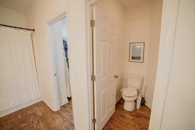 bathroom featuring hardwood / wood-style flooring and toilet