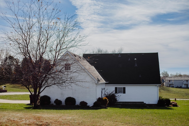 view of side of home with a lawn