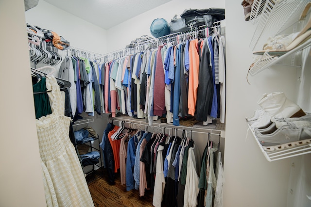 walk in closet with dark hardwood / wood-style flooring