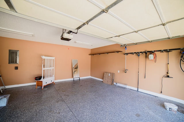 garage featuring electric panel and a garage door opener