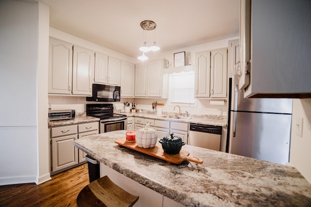 kitchen featuring dark hardwood / wood-style flooring, sink, black appliances, white cabinetry, and hanging light fixtures