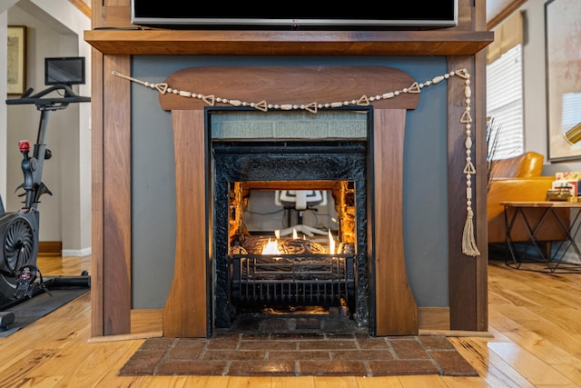 interior details with a premium fireplace and hardwood / wood-style floors