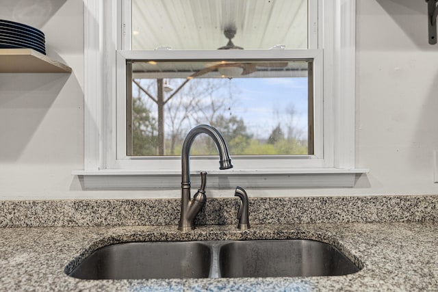 interior details featuring sink and light stone counters