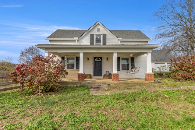 view of front of property featuring covered porch and a front lawn