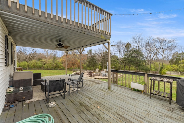 wooden deck featuring an outdoor hangout area, ceiling fan, and a lawn