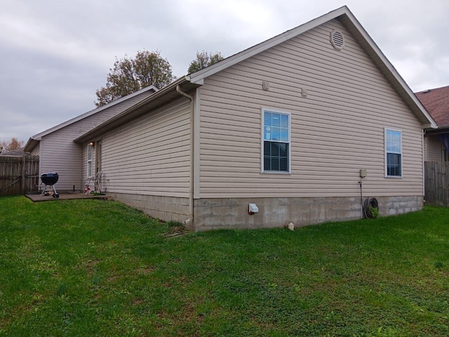 view of side of property with a yard and fence