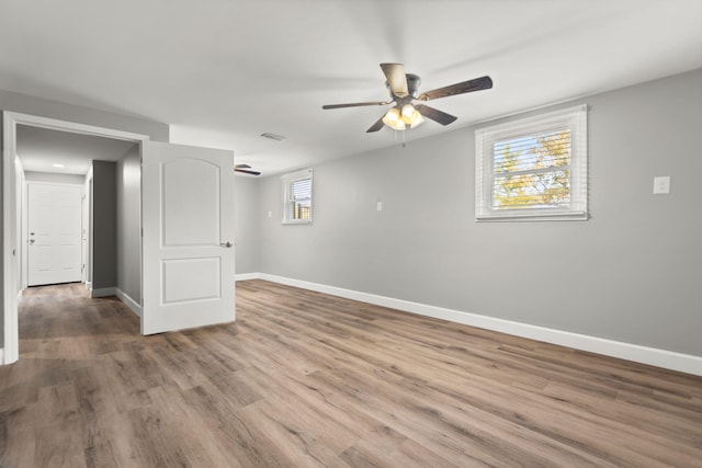 unfurnished room with ceiling fan and hardwood / wood-style floors