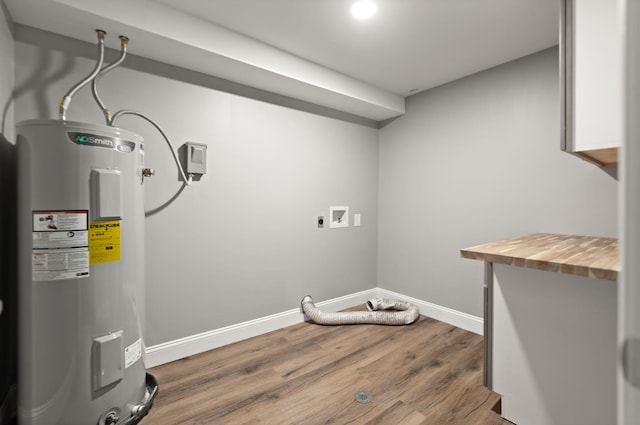 clothes washing area with washer hookup, hardwood / wood-style flooring, and water heater