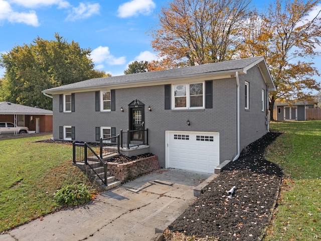 bi-level home featuring a front yard and a garage