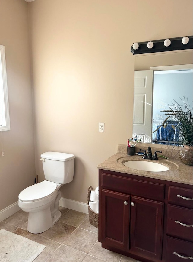 bathroom featuring tile patterned flooring, vanity, and toilet