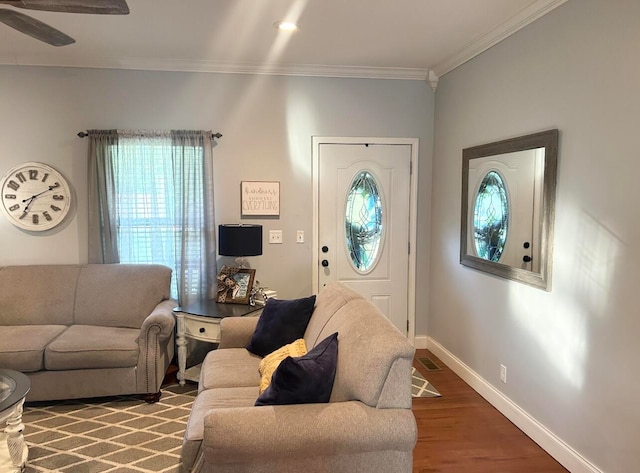 living room with hardwood / wood-style flooring, ceiling fan, and crown molding