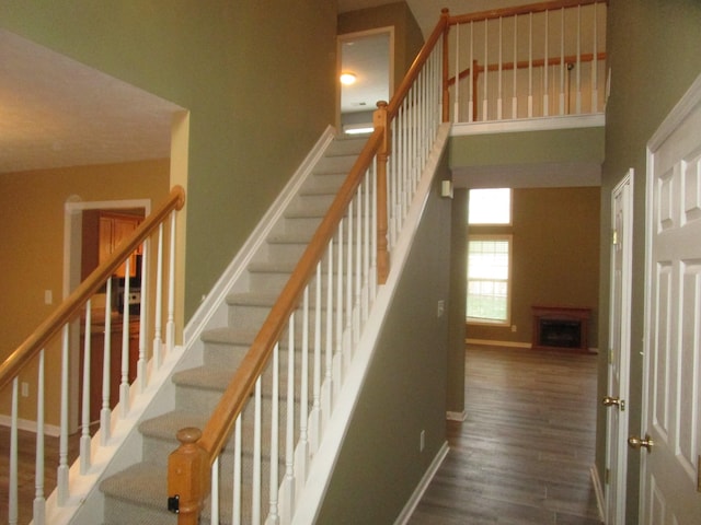 stairway with hardwood / wood-style floors