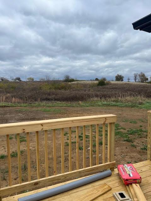 wooden terrace featuring a rural view