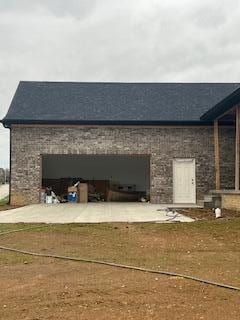 rear view of house with an attached garage