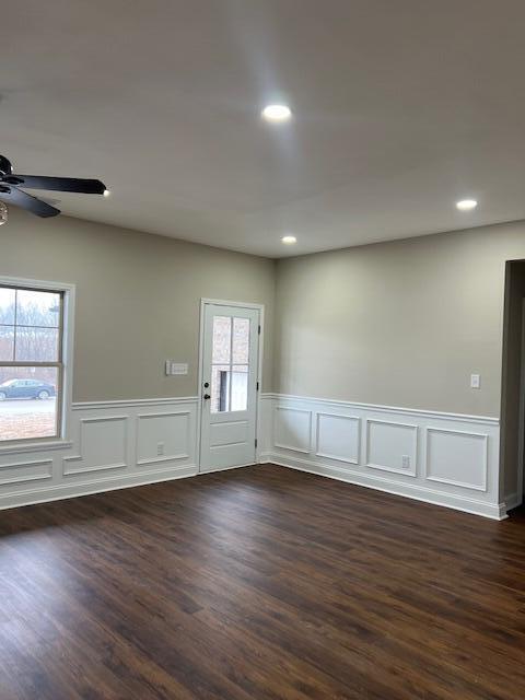 spare room with wainscoting, a ceiling fan, dark wood-style flooring, and recessed lighting