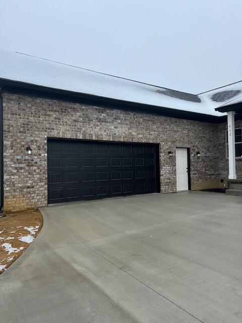 garage with concrete driveway