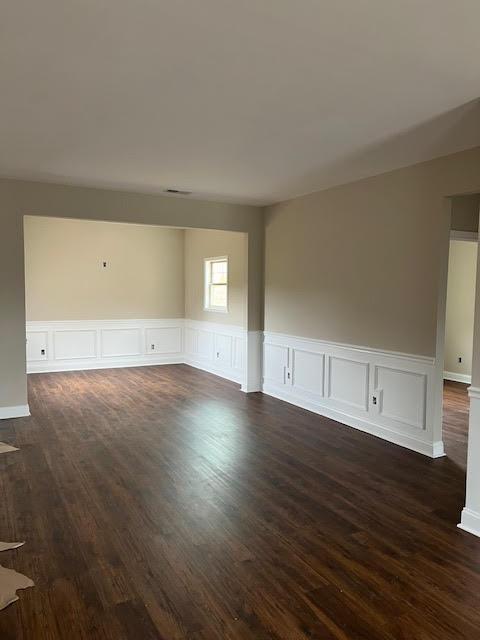 unfurnished room featuring dark wood-style flooring