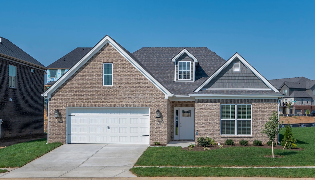 view of front of home with a front yard and a garage