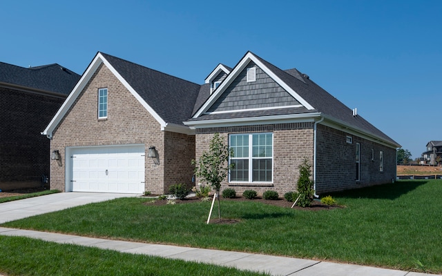 view of front of home with a front yard and a garage