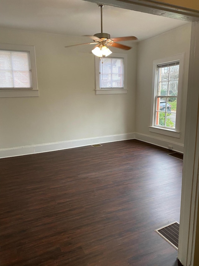 unfurnished room with ceiling fan and dark wood-type flooring