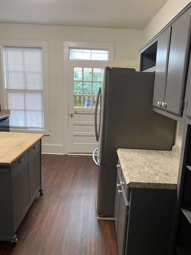 kitchen featuring dark wood-type flooring and stainless steel refrigerator