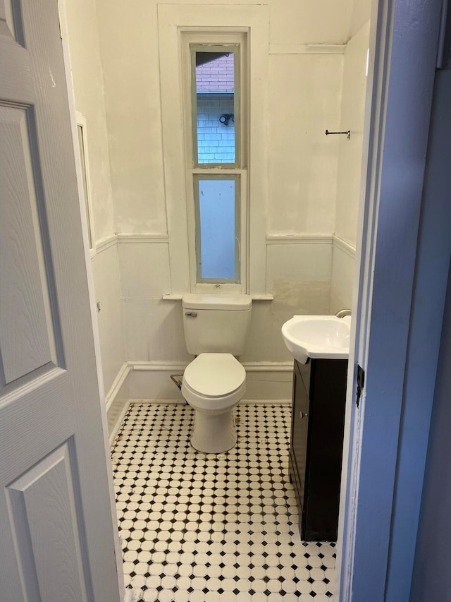 bathroom featuring tile patterned floors, vanity, and toilet