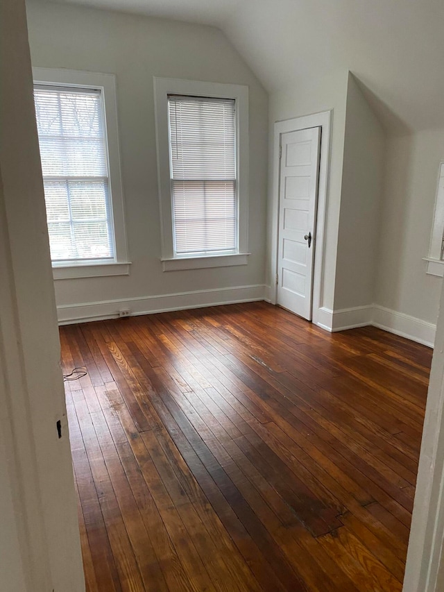 additional living space featuring dark hardwood / wood-style floors and vaulted ceiling