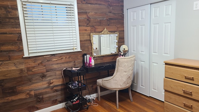 home office with hardwood / wood-style floors and wood walls