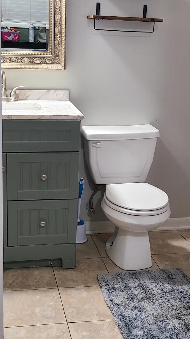 bathroom featuring tile patterned flooring, vanity, and toilet