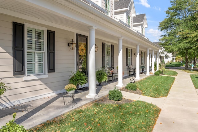 view of exterior entry with a porch