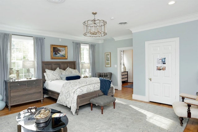 bedroom with light wood-type flooring, an inviting chandelier, ornamental molding, and multiple windows