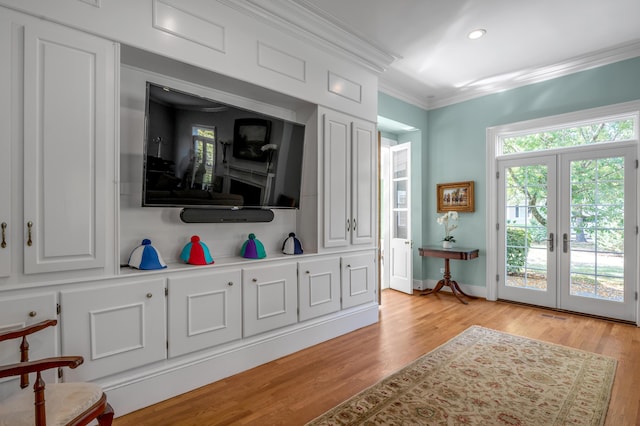 interior space featuring light hardwood / wood-style flooring, crown molding, and french doors