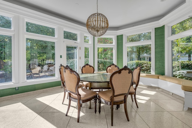 sunroom / solarium with a chandelier