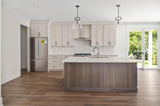 1602 Winners Cir # 41, Lexington, KY 40513 - kitchen featuring high end refrigerator, wall chimney range hood, light countertops, tasteful backsplash, and a kitchen island with sink