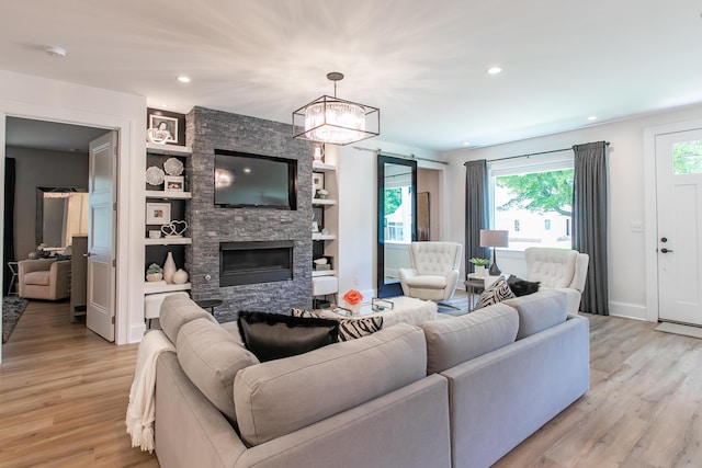 1602 Winners Cir # 41, Lexington, KY 40513 - living room featuring light wood-style floors, recessed lighting, a stone fireplace, a chandelier, and built in shelves