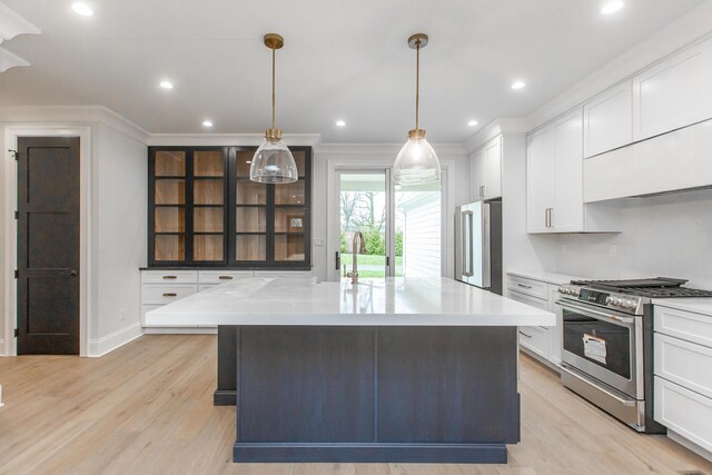 1602 Winners Cir # 41, Lexington, KY 40513 - kitchen with gas range, fridge, light wood finished floors, a center island, and white cabinets