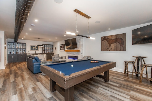 game room featuring a fireplace, pool table, and hardwood / wood-style floors