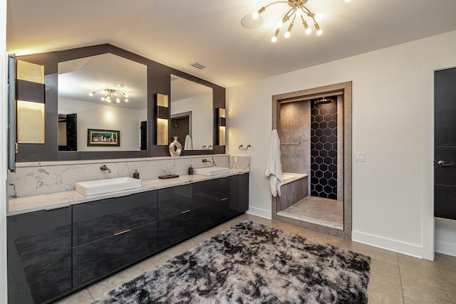 bathroom featuring tile patterned floors, vanity, a chandelier, vaulted ceiling, and tiled shower