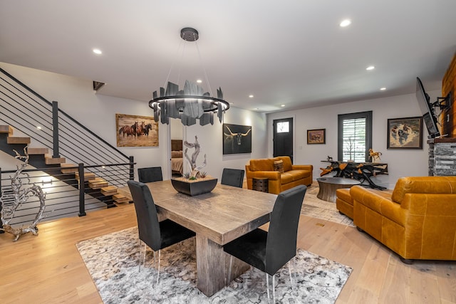 dining space featuring an inviting chandelier and light wood-type flooring