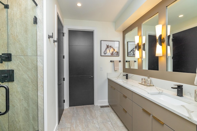 bathroom featuring an enclosed shower and vanity