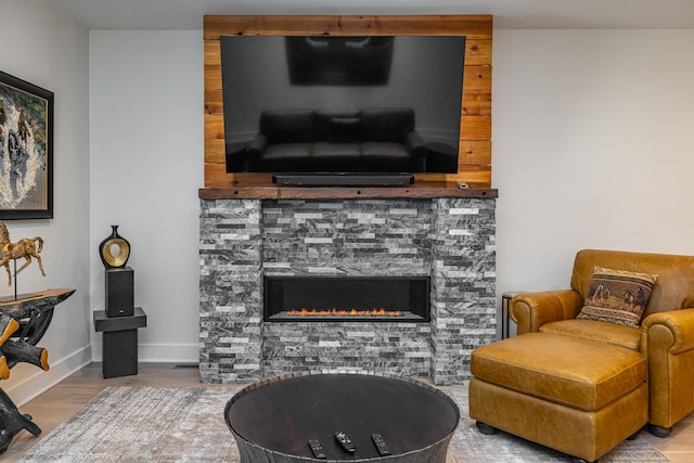 living room with light hardwood / wood-style flooring and a fireplace