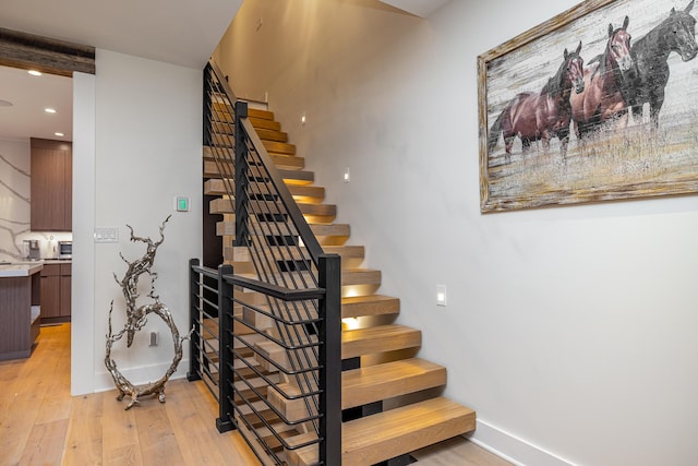 stairs featuring wood-type flooring