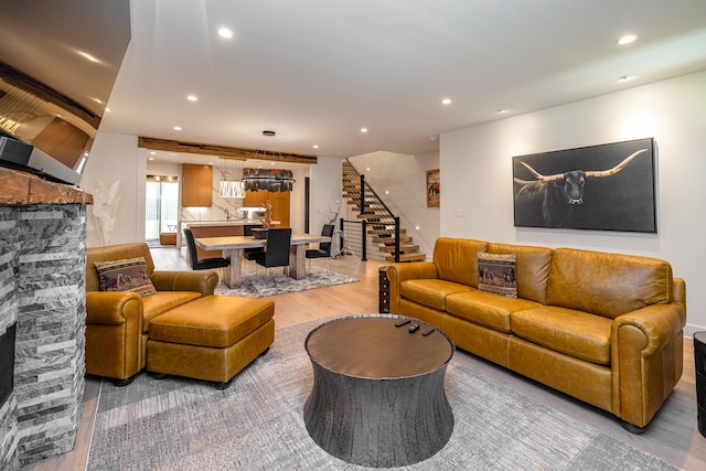 1602 Winners Cir # 41, Lexington, KY 40513 - living area featuring a stone fireplace, stairs, recessed lighting, and light wood-style floors
