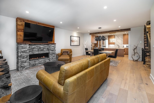 living room featuring a fireplace and light hardwood / wood-style flooring