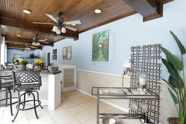 kitchen with a kitchen bar, wooden ceiling, beam ceiling, and kitchen peninsula