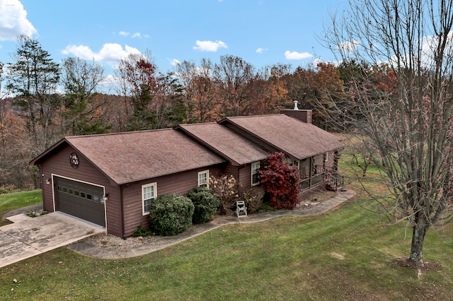 single story home featuring a porch, a garage, and a front lawn