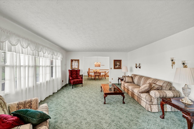 carpeted living room featuring a textured ceiling and a notable chandelier