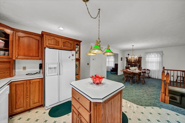 kitchen featuring a center island, a notable chandelier, light colored carpet, pendant lighting, and white appliances