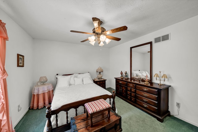 carpeted bedroom with ceiling fan and a textured ceiling