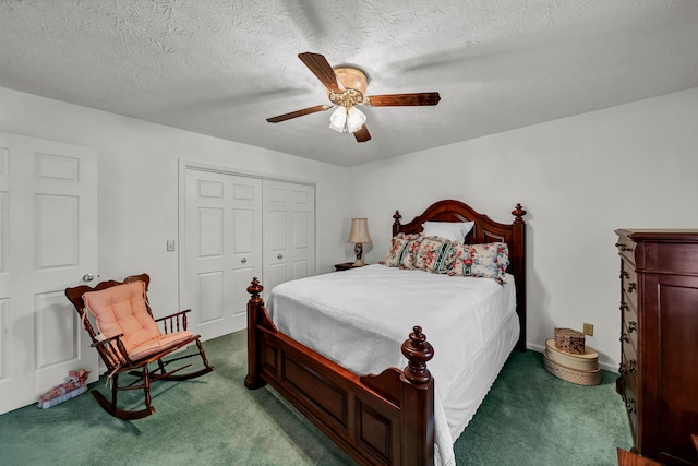 carpeted bedroom featuring a textured ceiling, a closet, and ceiling fan